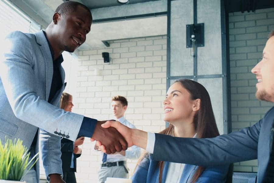 man shaking hiring manager hand after great interview