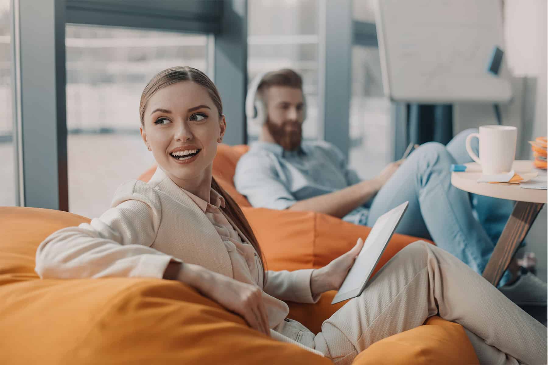 woman sitting in chair smiles after complimented on her perfect resume